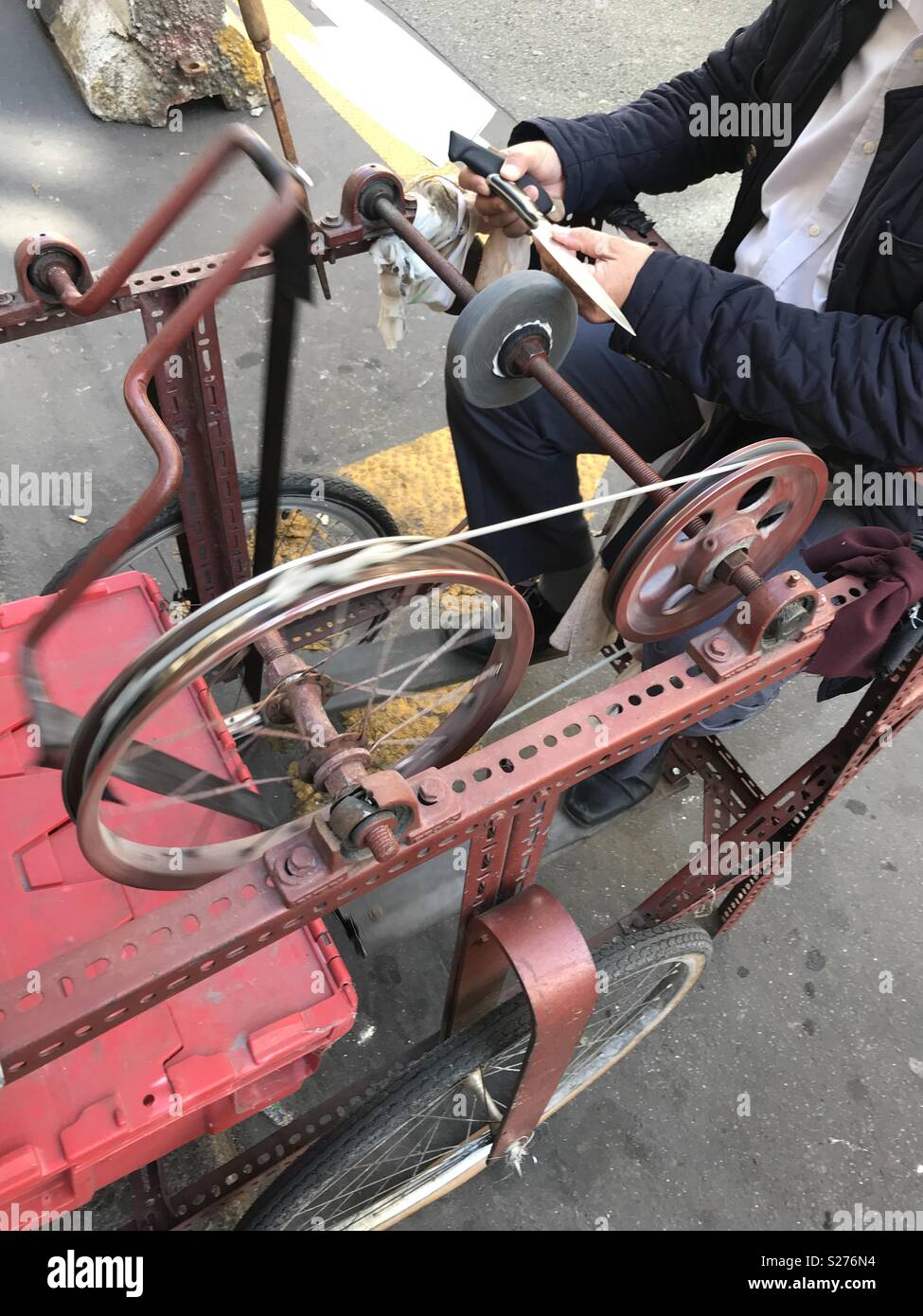 Paris, France. A knife sharpener with his tools - Smartphone Captured Stock Image