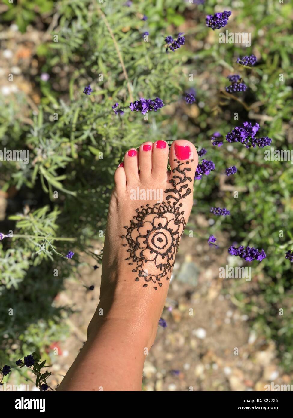 Summer party in the garden mendhi pattern on foot. Stock Photo