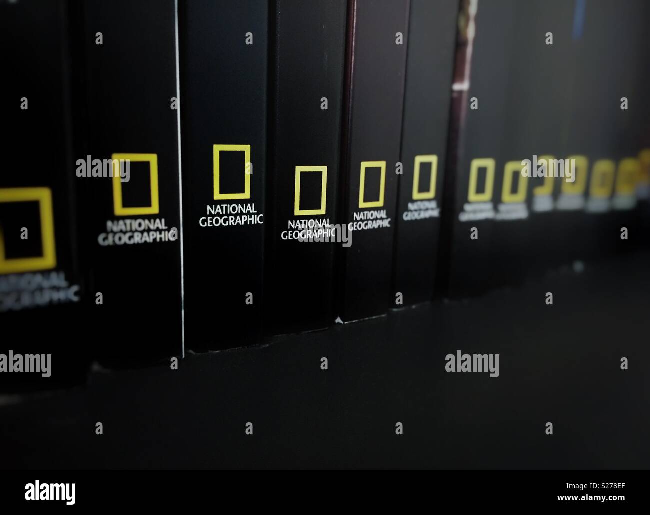 Rome, italy, June 29th 2018: spines of books stored in a black shelf with the National Geographic logo - Smartphone Captured Stock Image