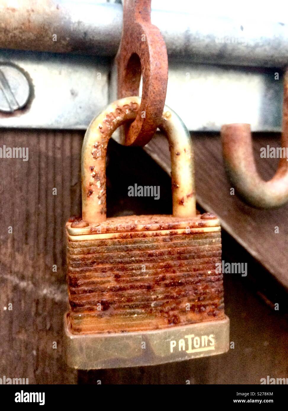 Rusty padlock on a garden gate Stock Photo