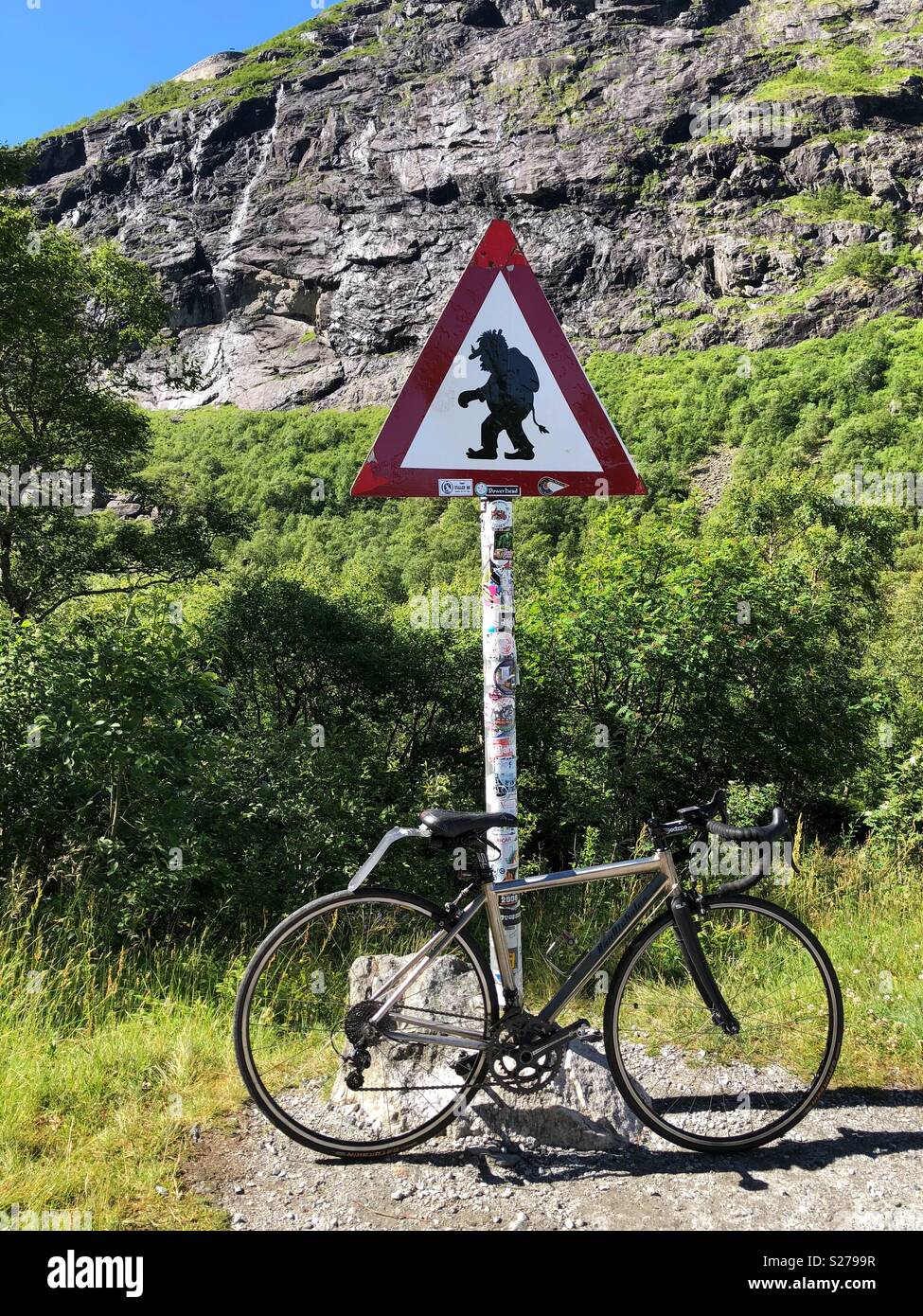 Cycle leaning against a troll sigh post on the Trollstigen pass, Norway - Smartphone Captured Stock Image