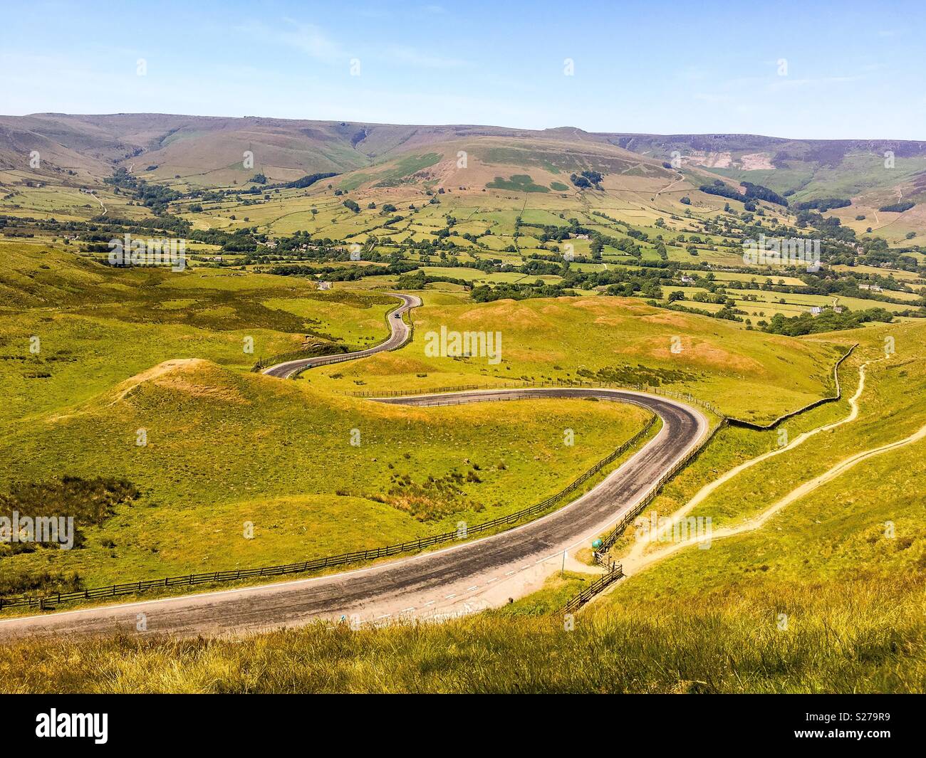 A rural road snakes its way through the Peak District, Derbyshire Stock