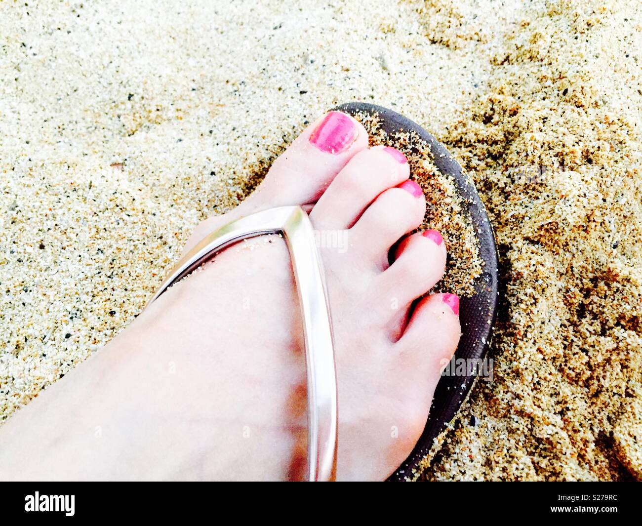 Elegantly manicured toes in sand and sandal - Smartphone Captured Stock Image