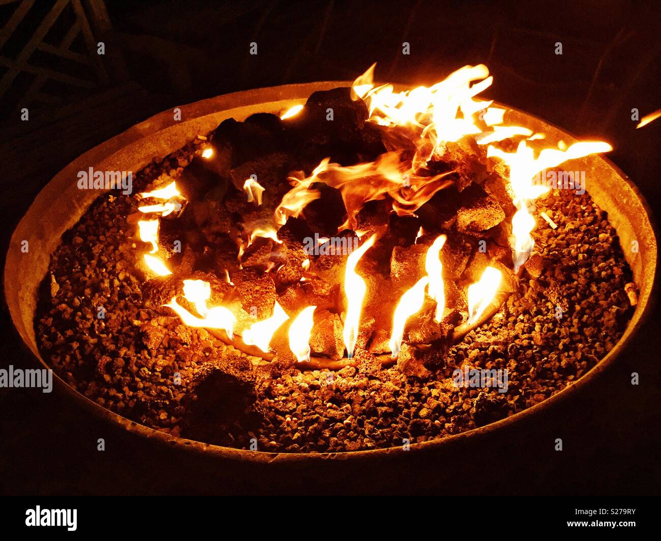 Tropical island beachside fire ring keeps beach goers warm at nighttime