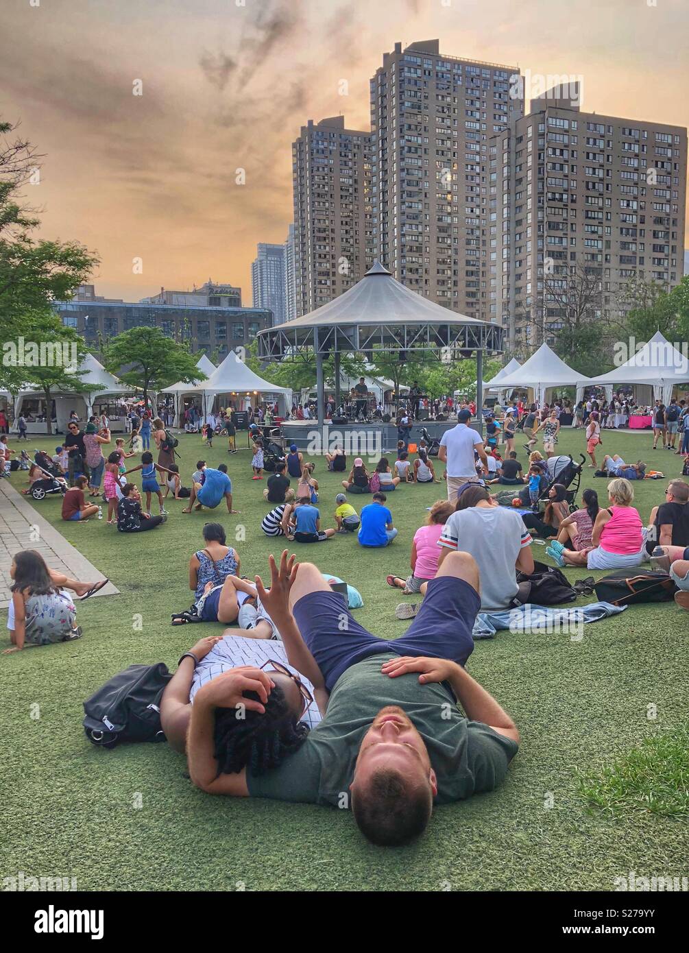 People relaxing at Harbourfront Centre listening to a band play. - Smartphone Captured Stock Image