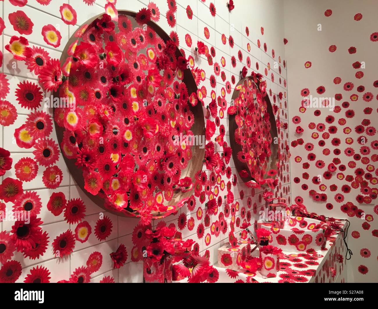 Flower stickers in a bathroom as an art installation Stock Photo