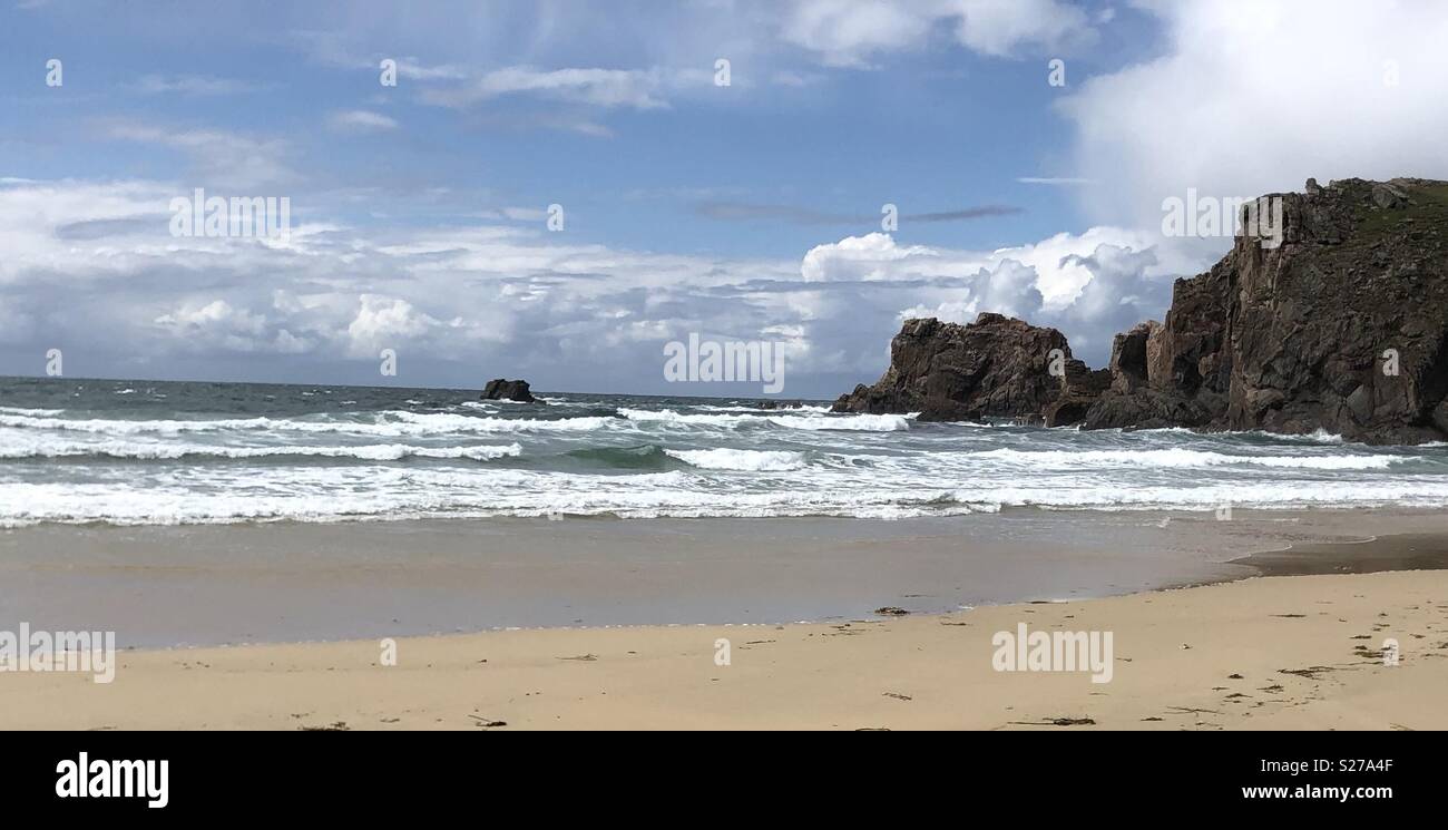 Beach with white waves and rocky coastline - Smartphone Captured Stock Image