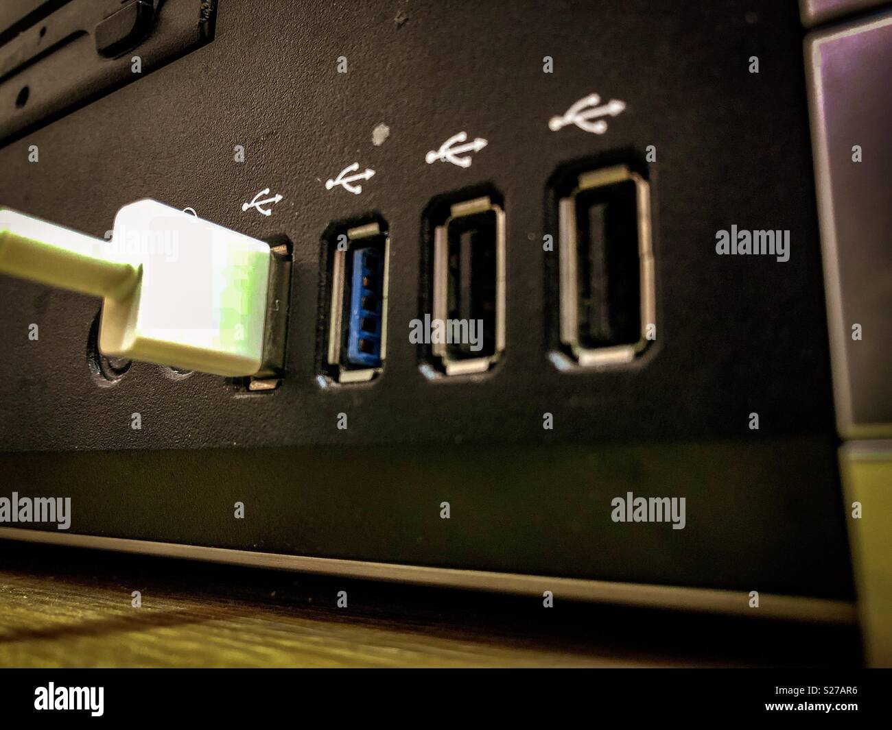 Usb cable plugged to a computer - Smartphone Captured Stock Image