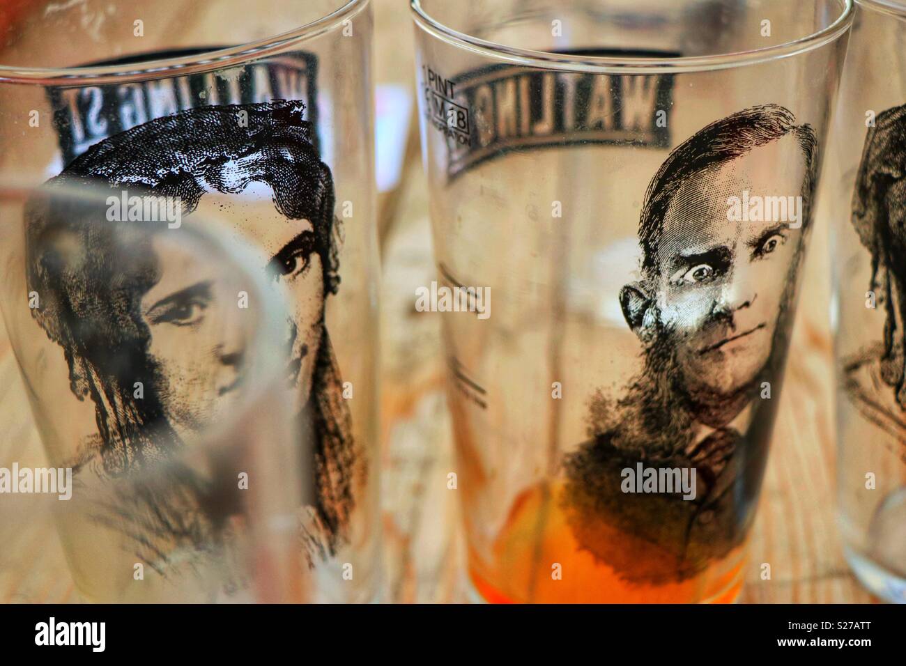 Watling Street Brewery, Watford, U.K. Two of the cleverly designed beer glasses at the Hertfordshire Brewery, celebrating significant figures in the history of Watling Street. - Smartphone Captured Stock Image