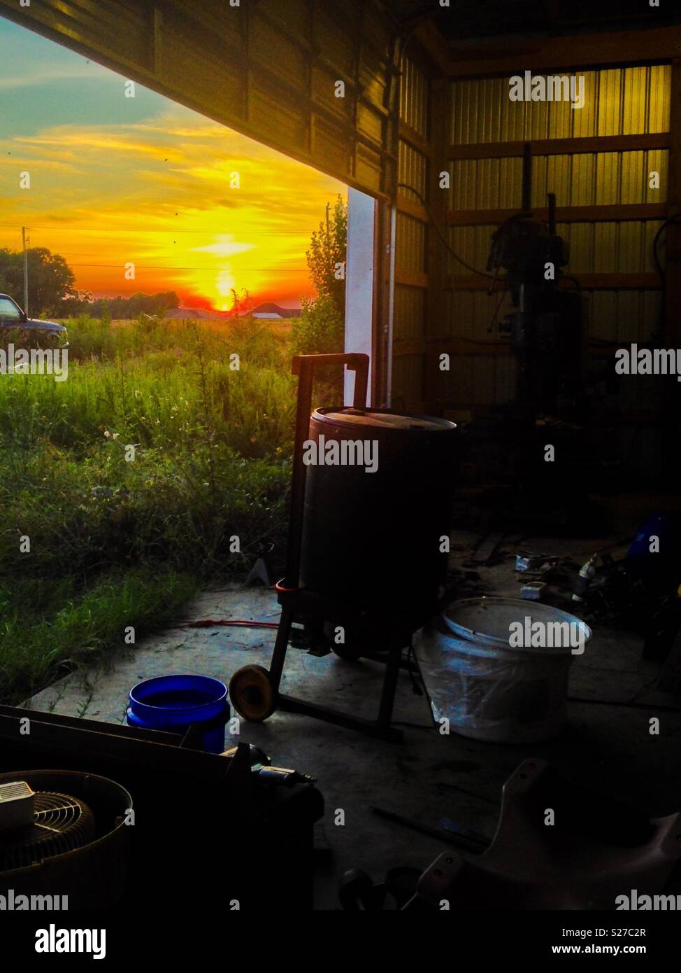 Golden Sunset Outside Garage Door Opening In Shed Containing Honey