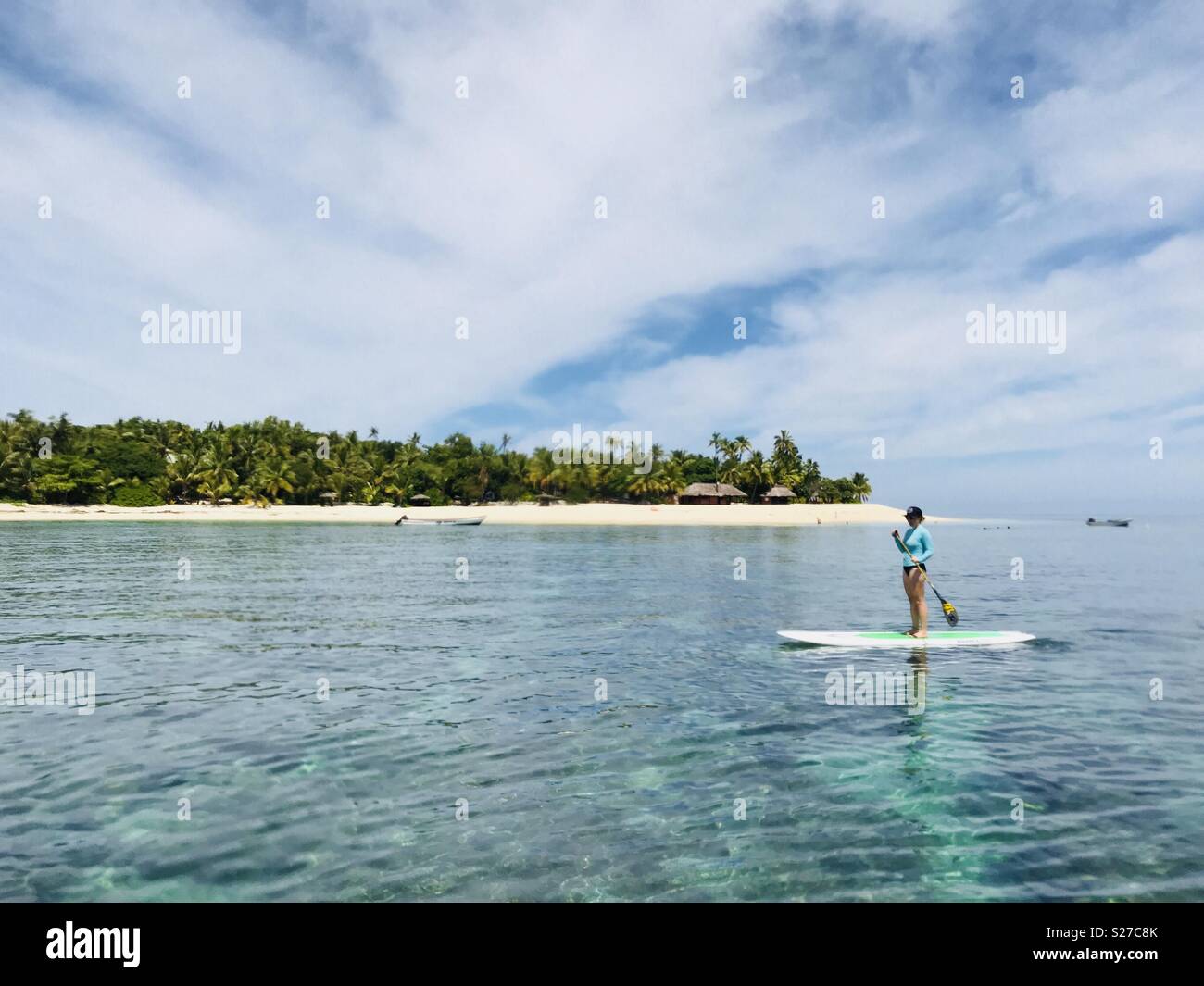 A female stand up paddling. Tavarua island, Fiji. - Smartphone Captured Stock Image