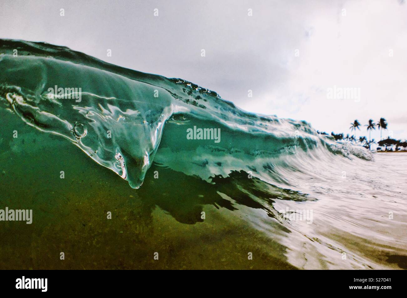 Close up of an ocean wave breaking near shore. Stock Photo