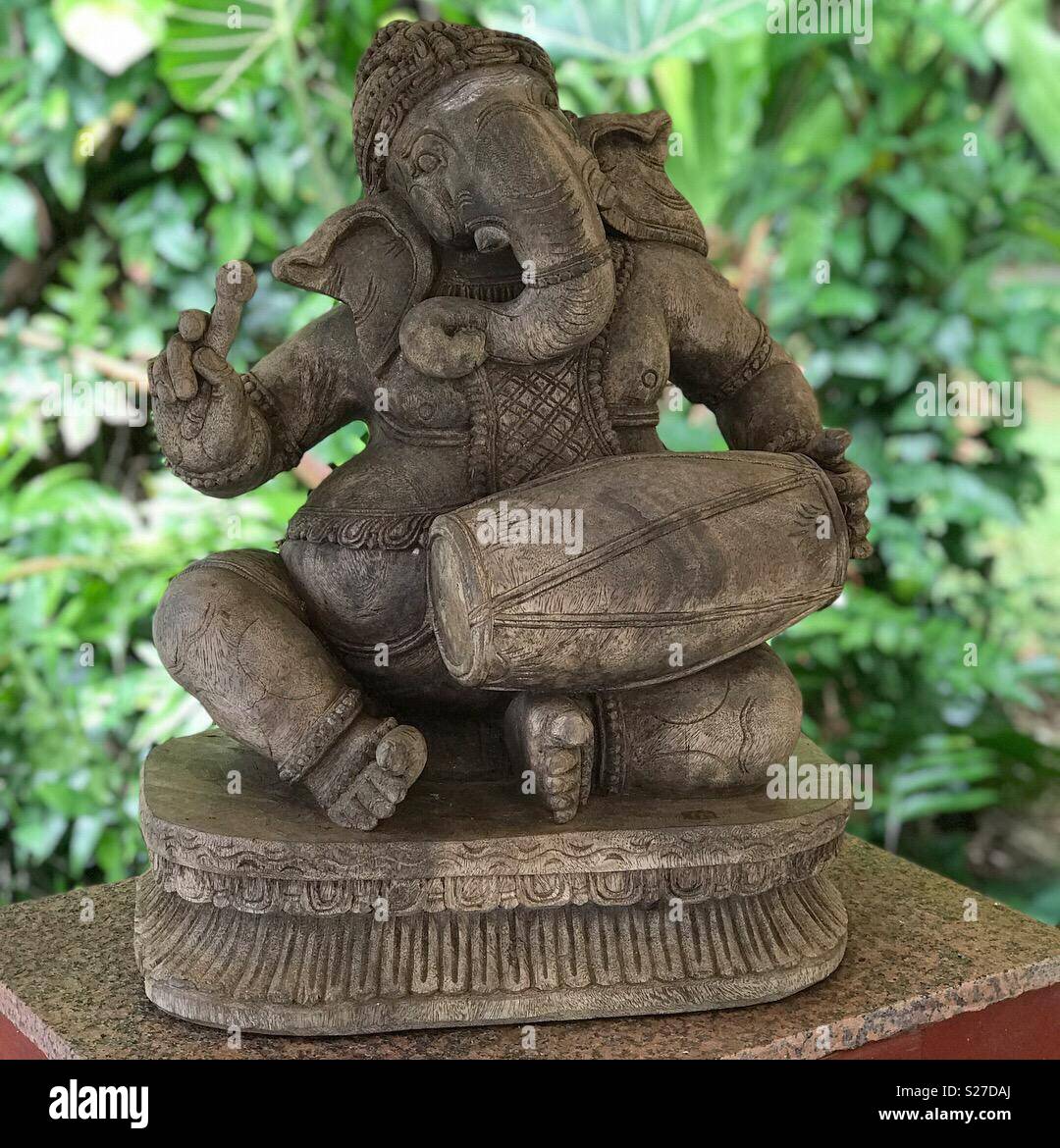 Kapaa, Kauai, HI / USA - June 10, 2018: A wood sculpture of the Hindu deity Ganesha is shown at the Saiva Siddhanta Temple of Kauai. - Smartphone Captured Stock Image