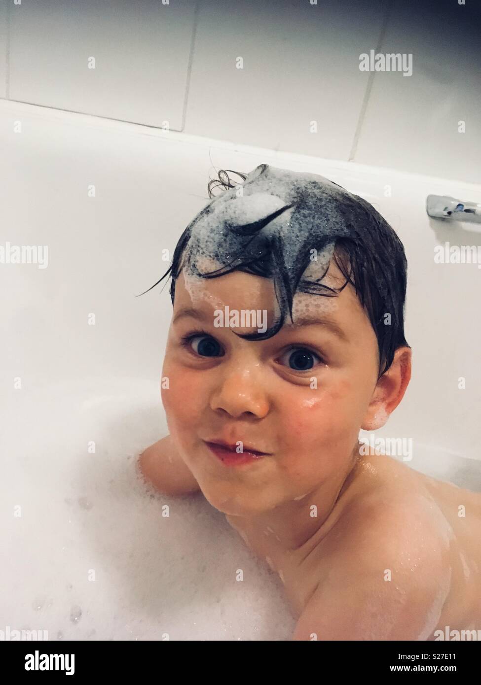 Cheeky boy in bath Stock Photo