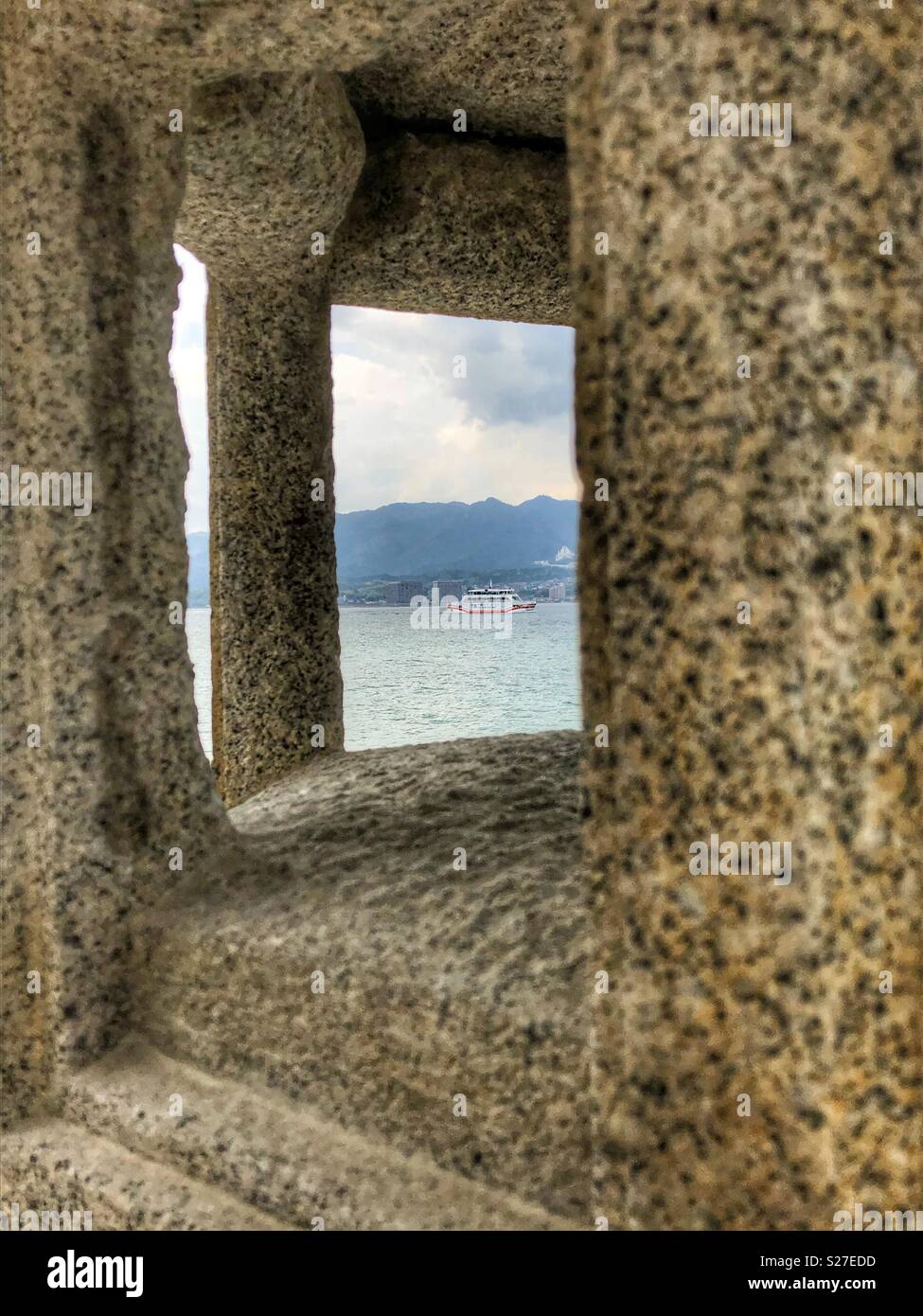 Looking through a square opening towards the sea. - Smartphone Captured Stock Image