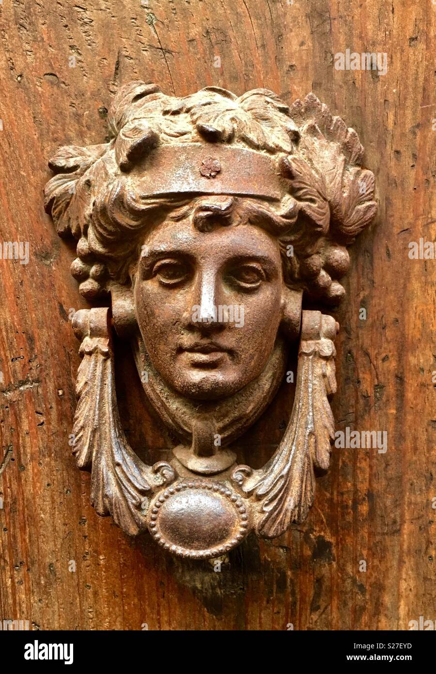 A traditional door handle in Rome, Italy. Stock Photo