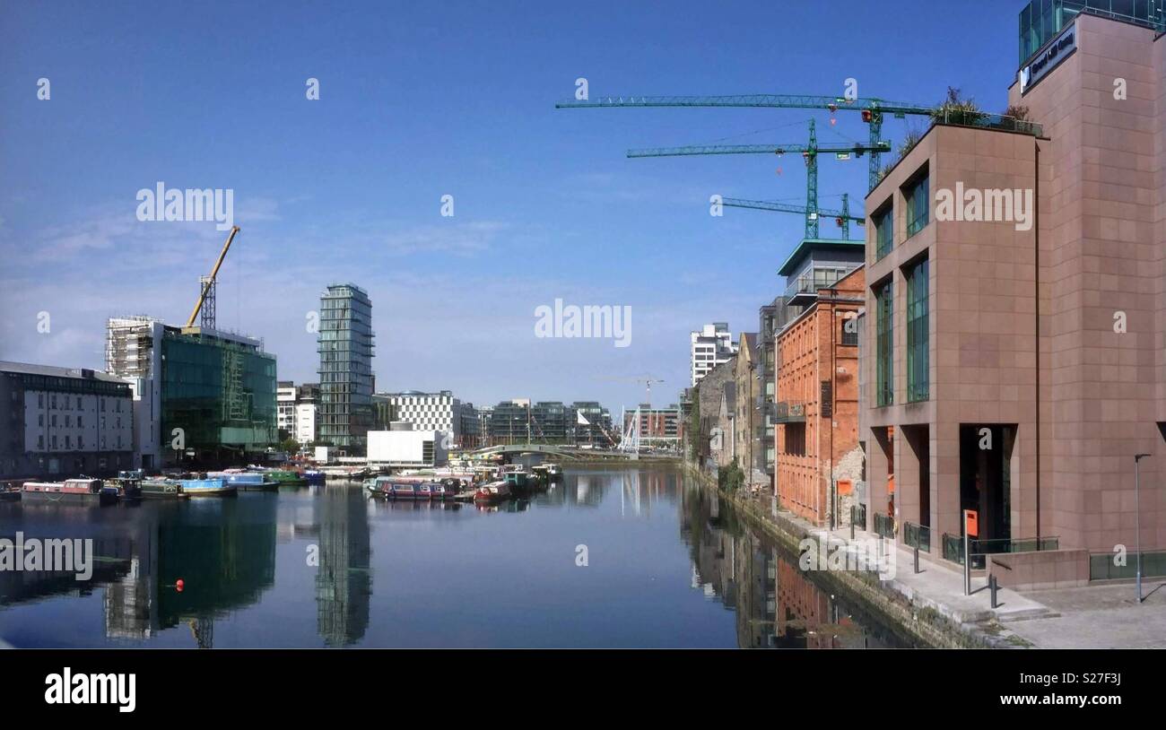 Houseboats moored in Grand Canal Dock, Dublin,Ireland. With The Marker Hotel in the background and construction cranes working overhead. - Smartphone Captured Stock Image