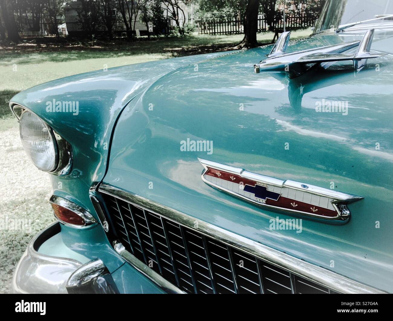 Pale photo of vintage Chevy Bel Aire grill, logo, and hood ornament Stock Photo