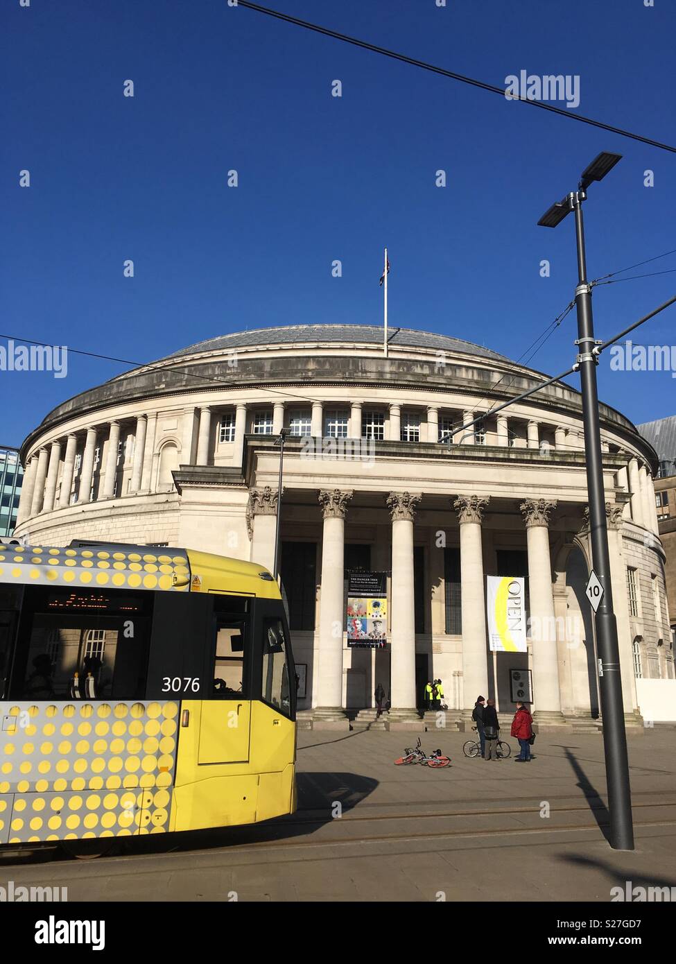 A tram going past Manchester Central Library Stock Photo