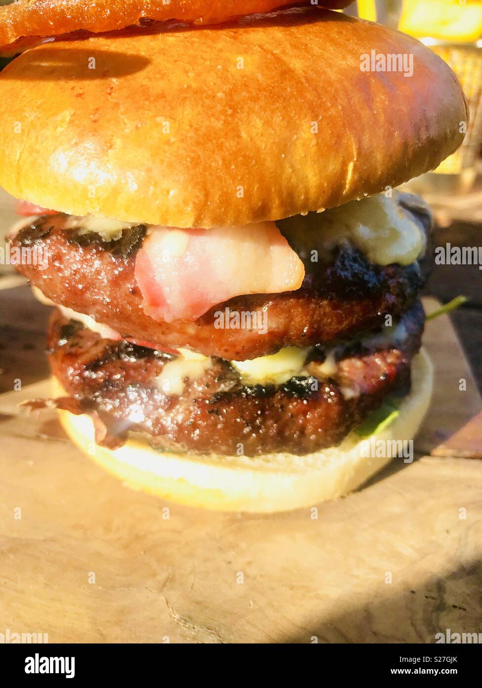 Double beef burger with bacon on a brioche bun Stock Photo Alamy