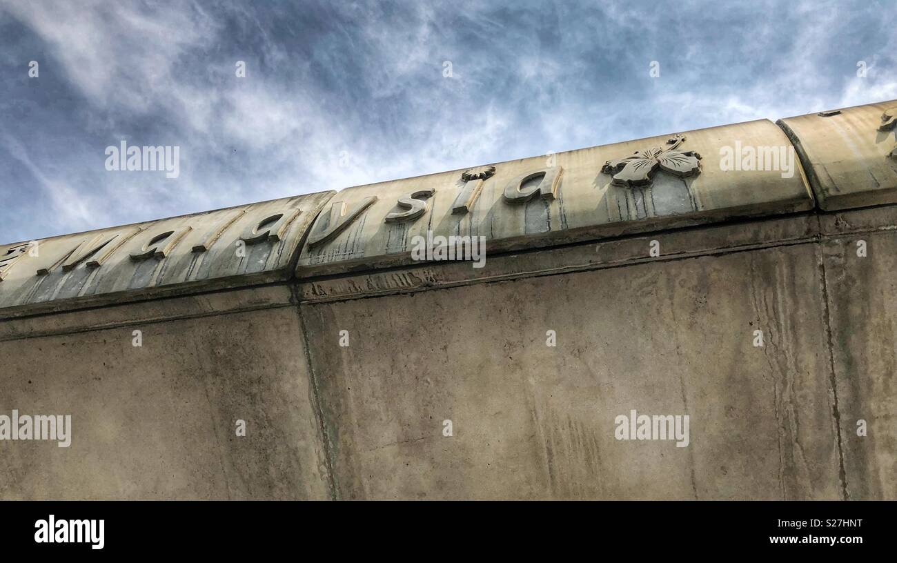 Raised letters spell Malaysia on the side of a concrete overpass in Kuala Lumpur. - Smartphone Captured Stock Image