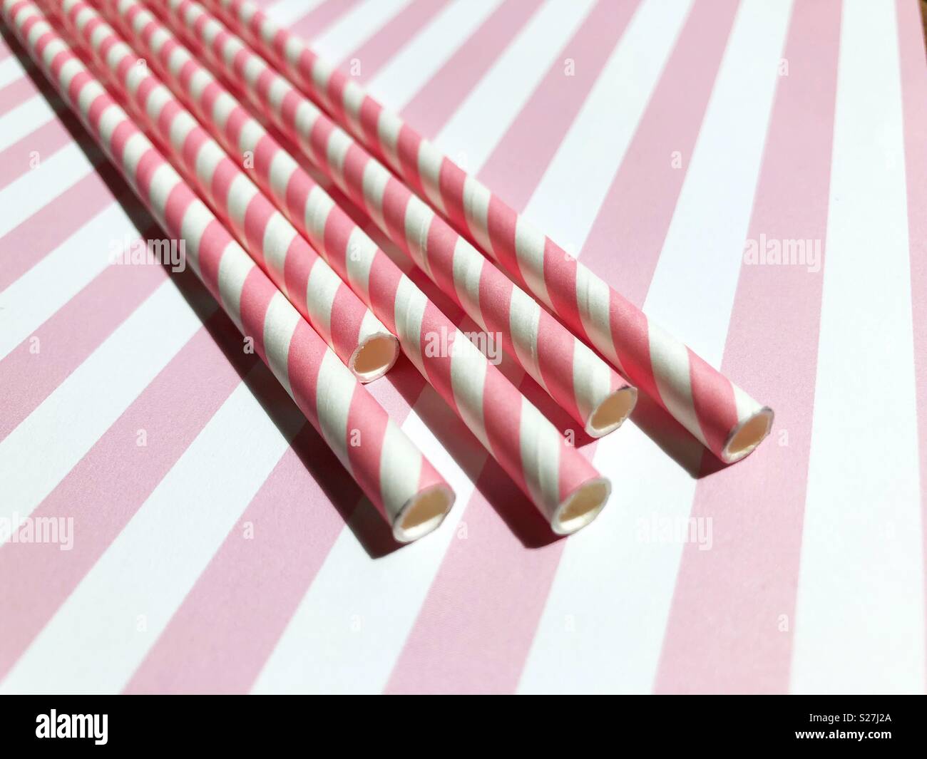 Pink and white striped paper straws. Stock Photo