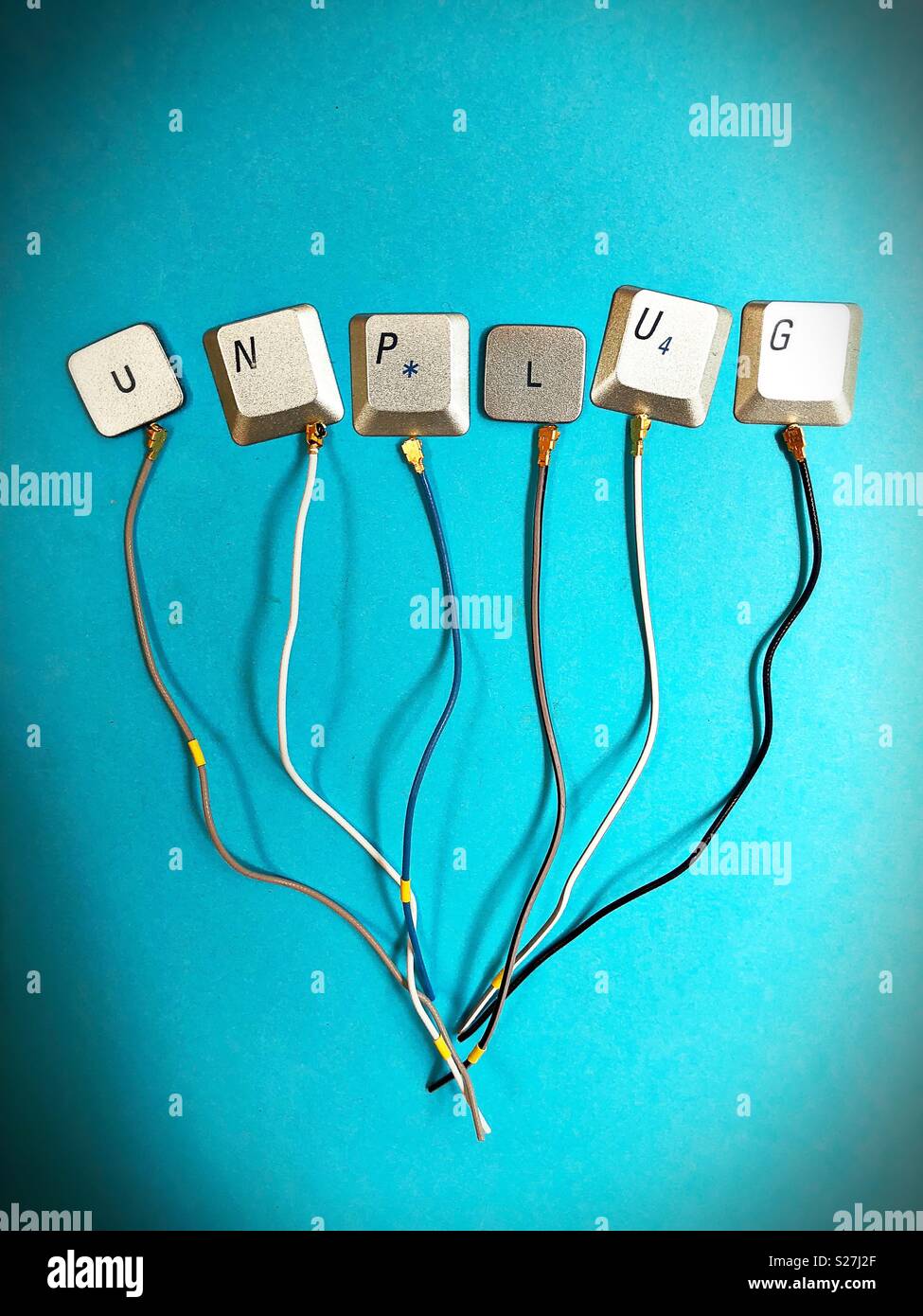 The word “unplug” made out of computer keyboard keys, and wire. Stock Photo