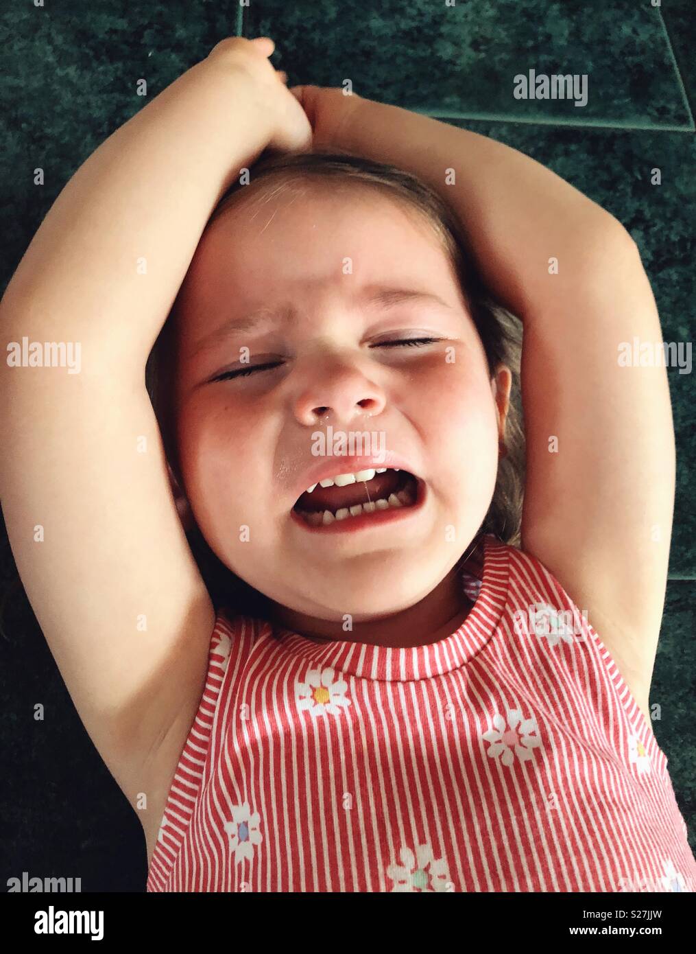 Closeup image of toddler girl face while having a temper tantrum Stock Photo