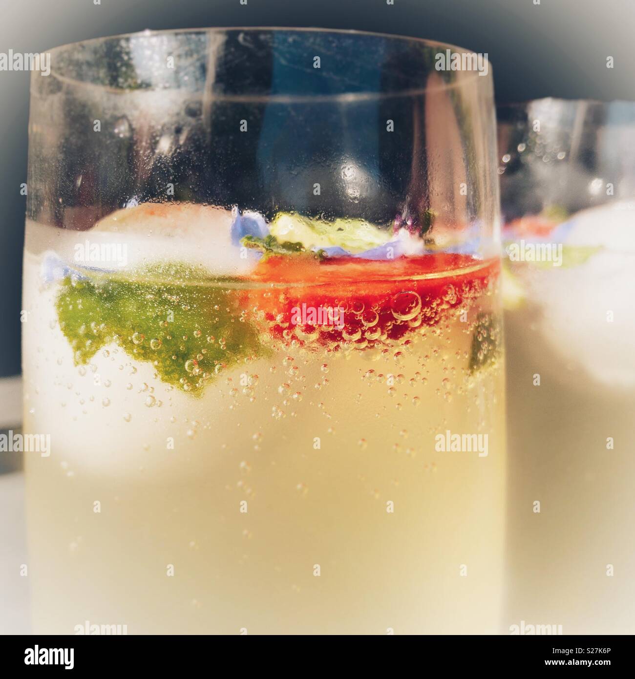 Glass of elderflower cordial with strawberry and mint leaves - Smartphone Captured Stock Image