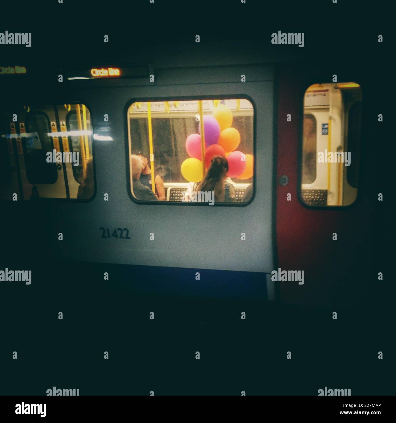 Brightly coloured balloons on London Underground train, Baker Street station - Smartphone Captured Stock Image