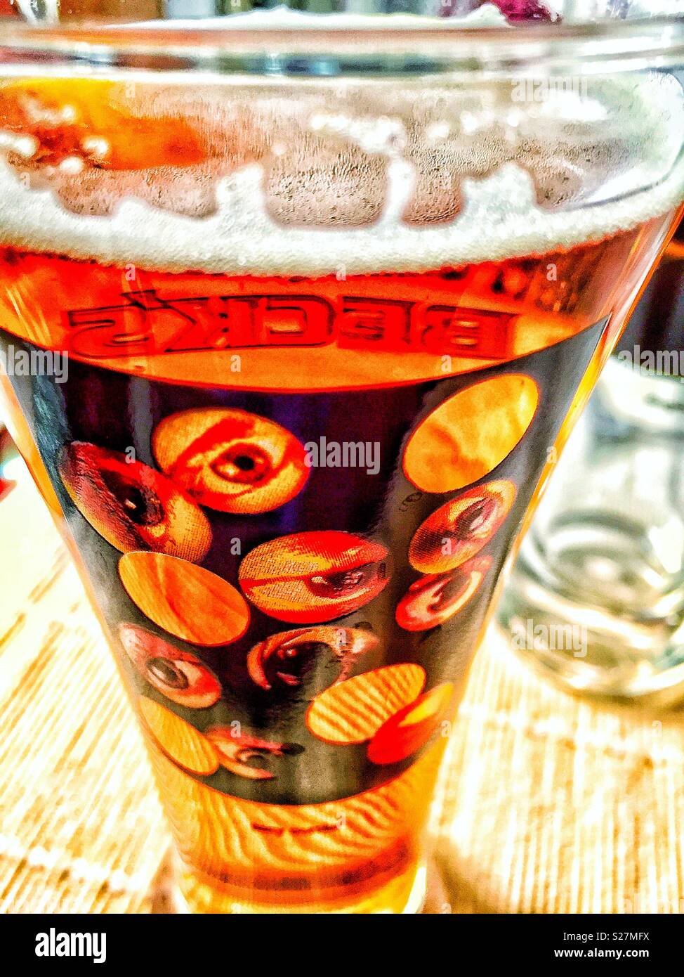 Classic designer Becks beer glass with eye design. - Smartphone Captured Stock Image