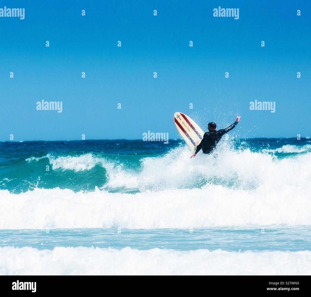 A surfer riding a big wave before a wipeout Stock Photo