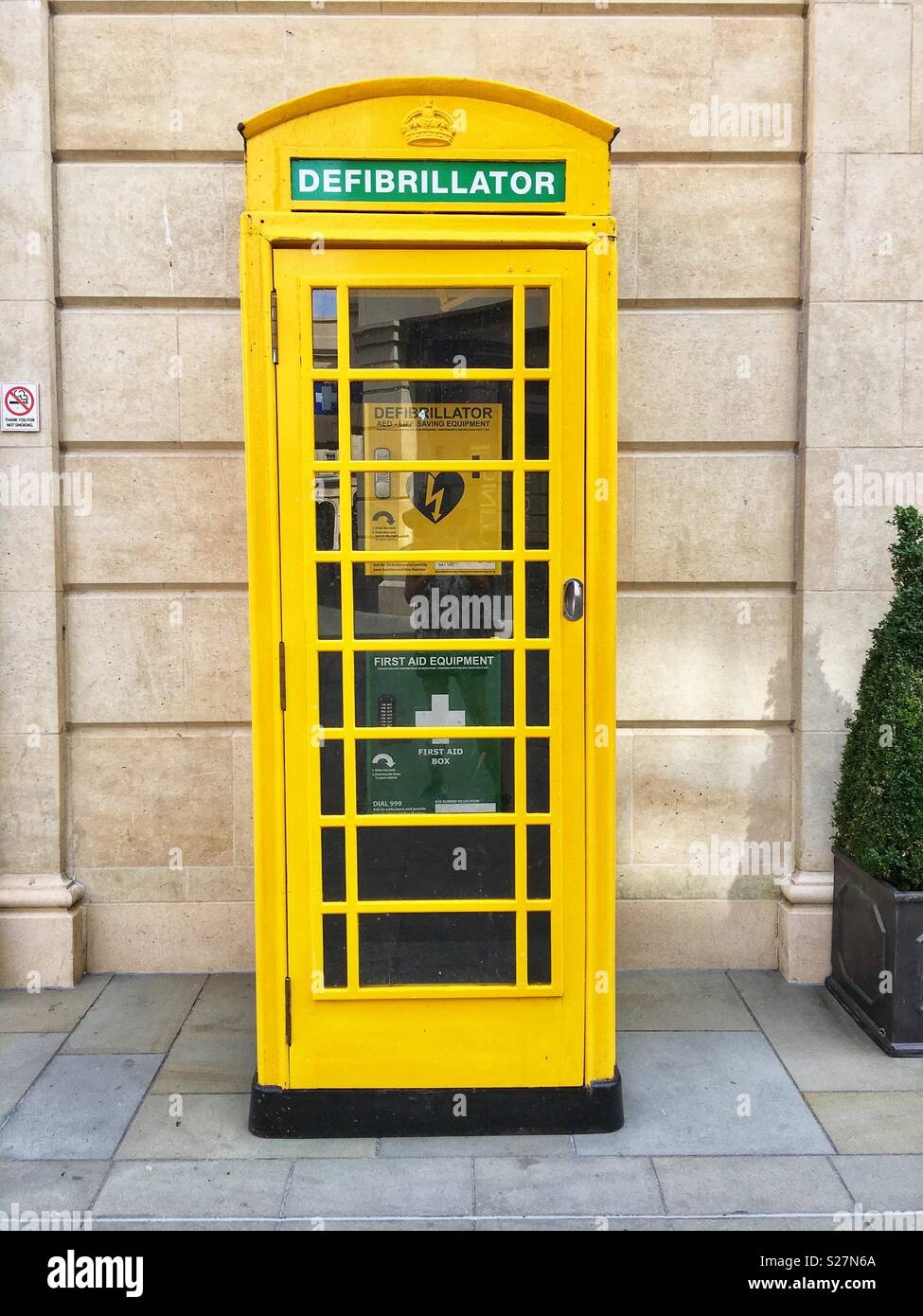 A former telephone booth has been repurposed to house a Defibrillator in Bath, England UK - Smartphone Captured Stock Image