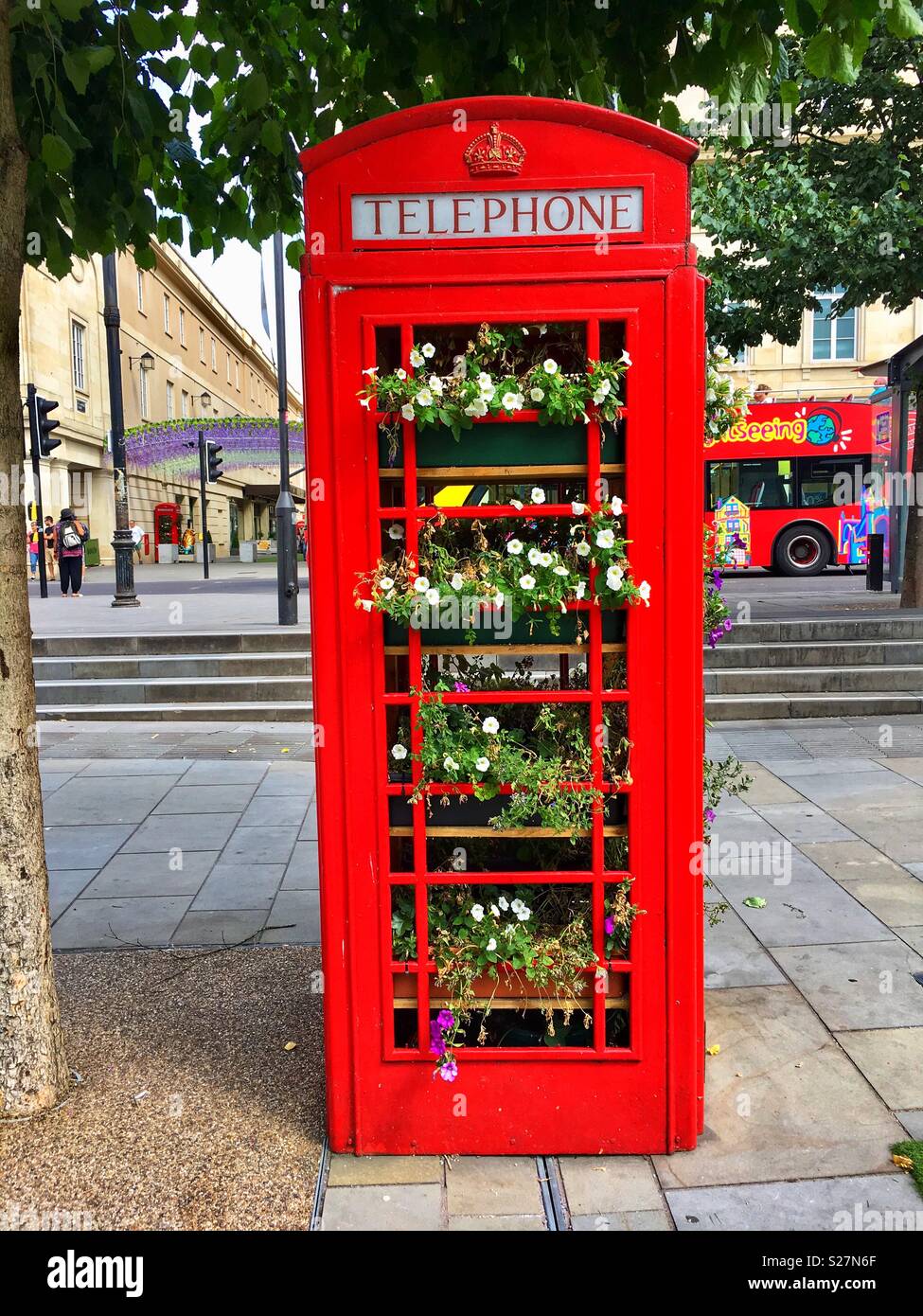 A former public telephone call box is repurposed to display flowers in Bath, England UK Stock Photo