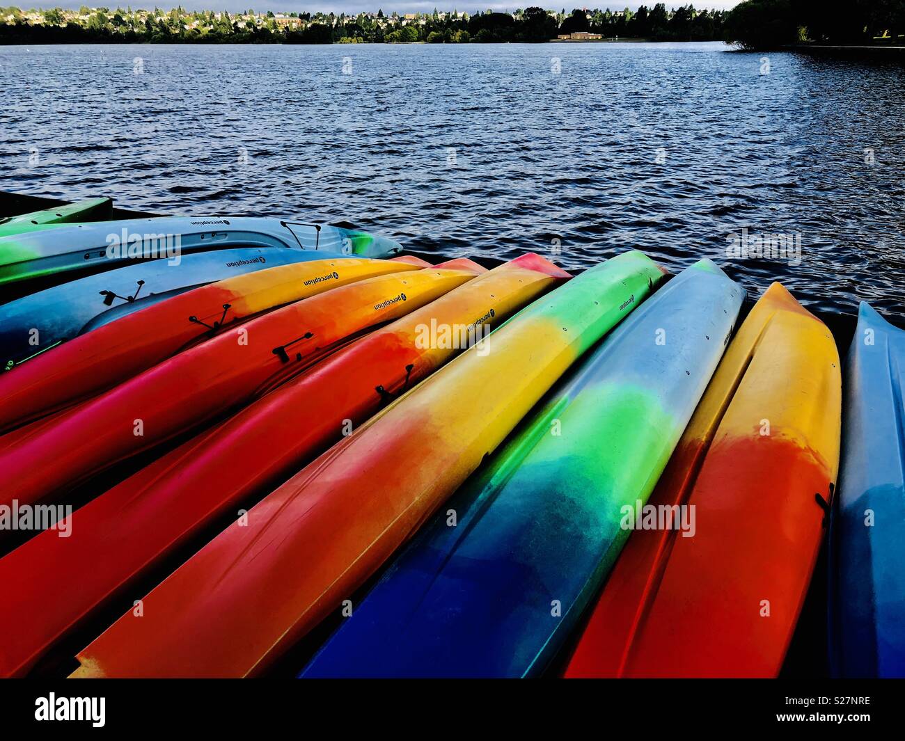 Green Lake in Seattle, USA early morning the kayaks are stacked up waiting for customers. - Smartphone Captured Stock Image