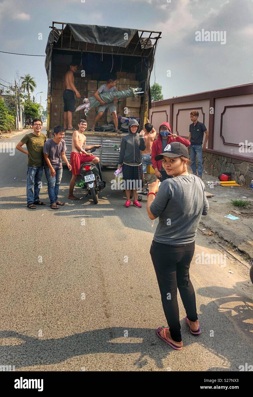 Friends getting ready to pose for the camera. - Smartphone Captured Stock Image
