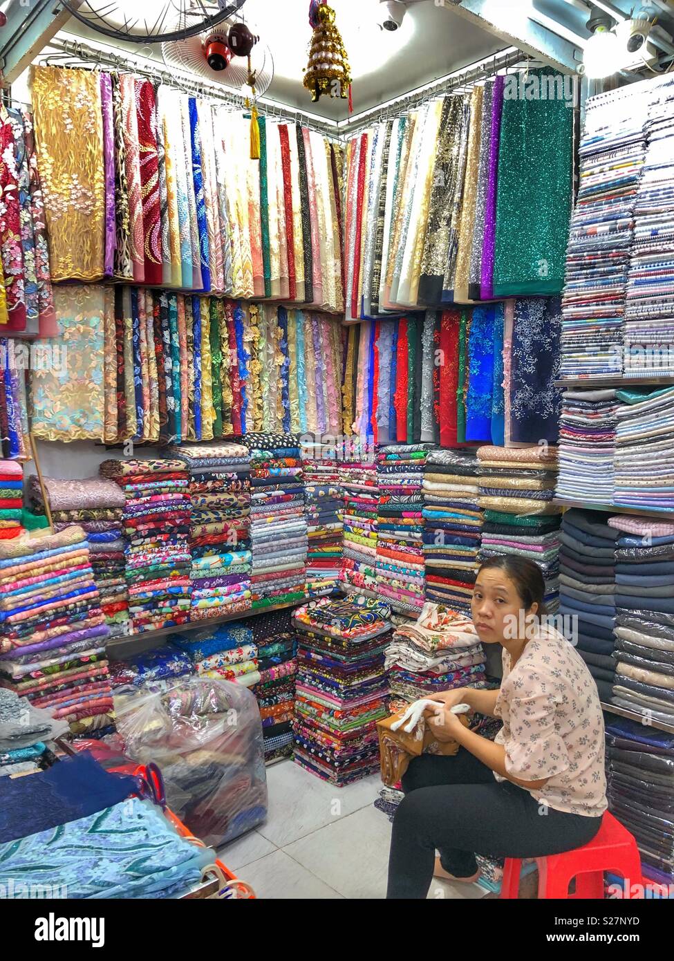 Fabric vendor in Cho Ben Thanh indoor market, Ho Chi Minh City, Vietnam. - Smartphone Captured Stock Image
