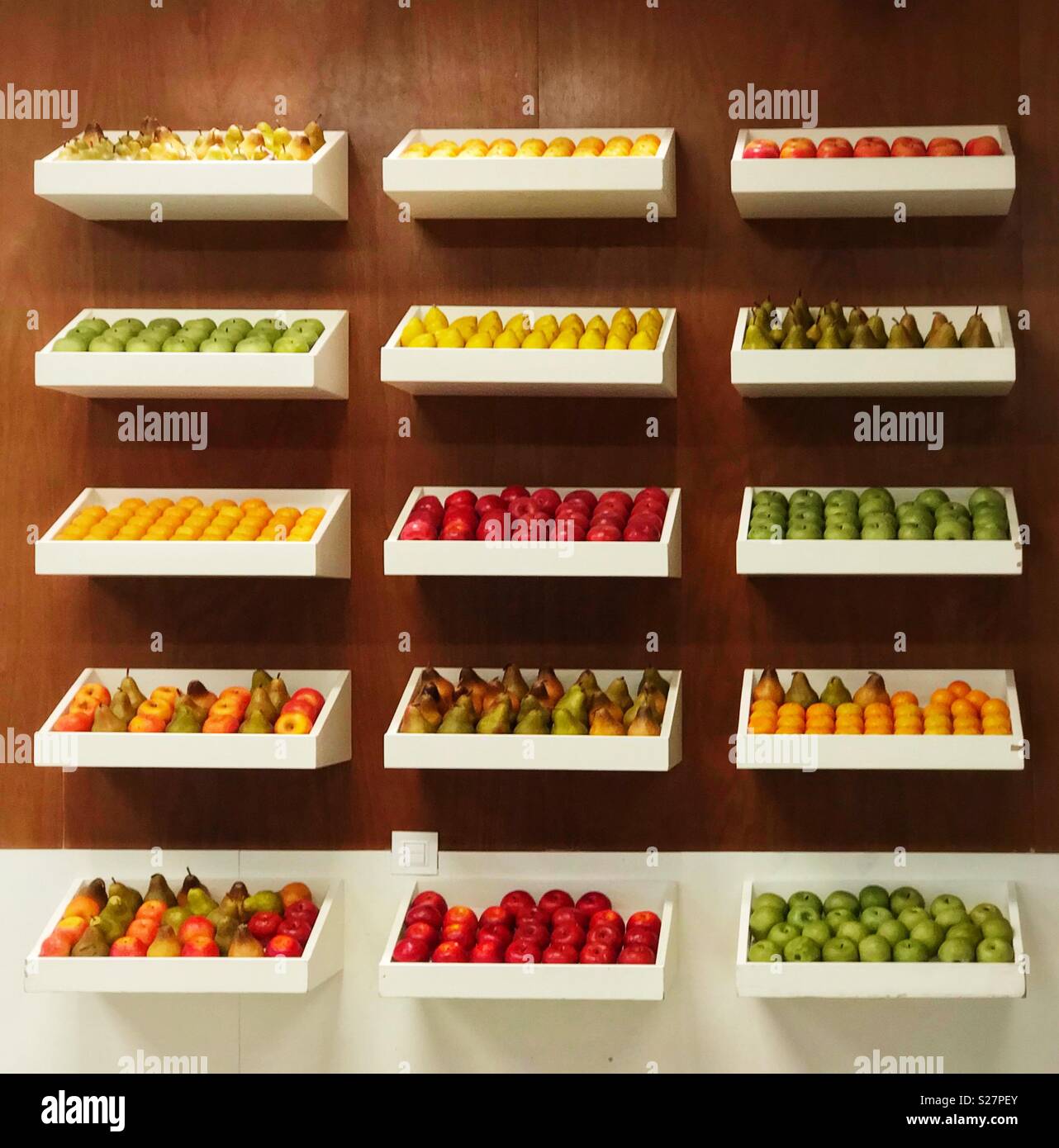 Display and storage shelves for brightly-coloured fresh fruit. - Smartphone Captured Stock Image