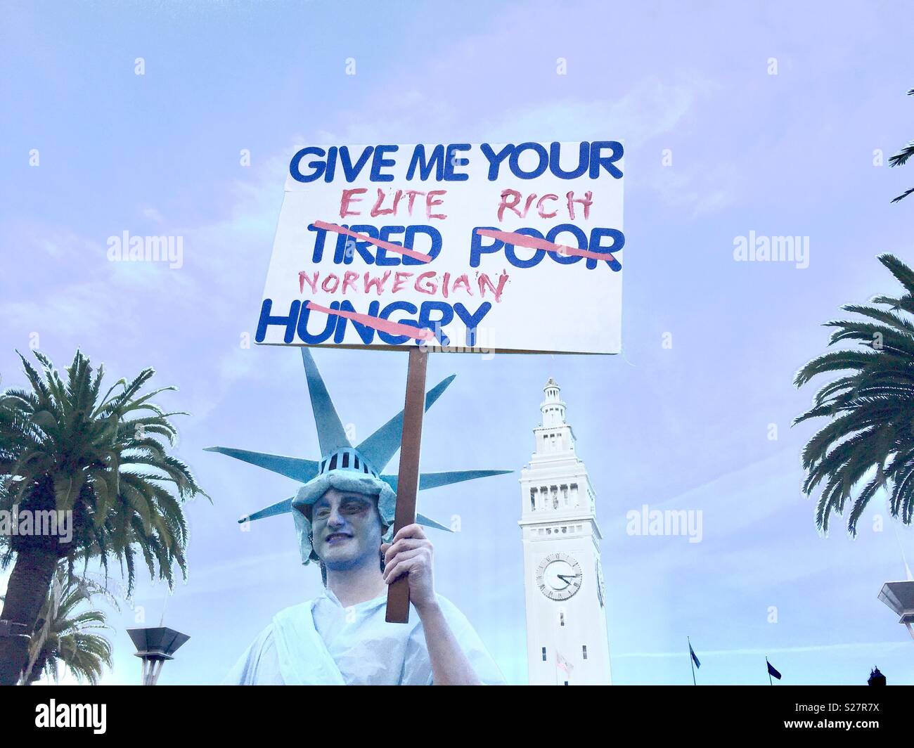 Protester dressed as the Statue of Liberty, with the Embarcadero clocktower behind him, San Francisco, California.  Women's March 2018. - Smartphone Captured Stock Image