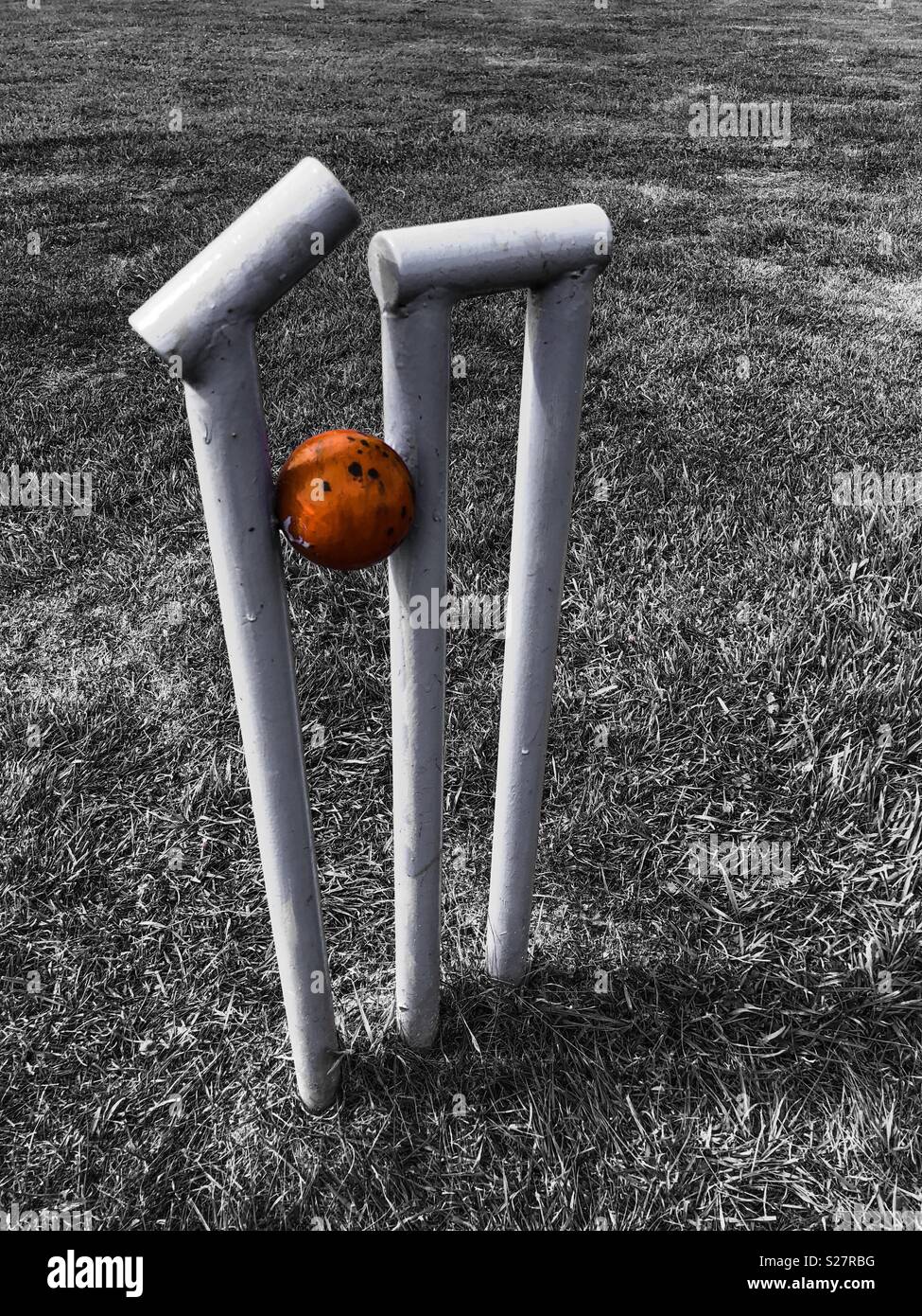 Howzat- bail knocked off wicket by a cricket ball. Part of an outdoor sculpture - Smartphone Captured Stock Image