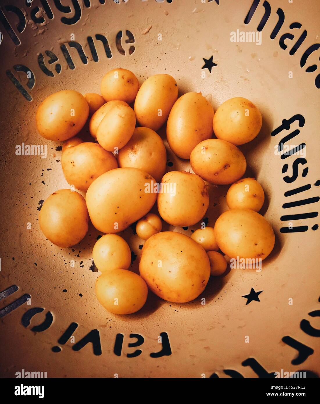 Freshly dug new potatoes, washed in a colander and ready to cook. - Smartphone Captured Stock Image