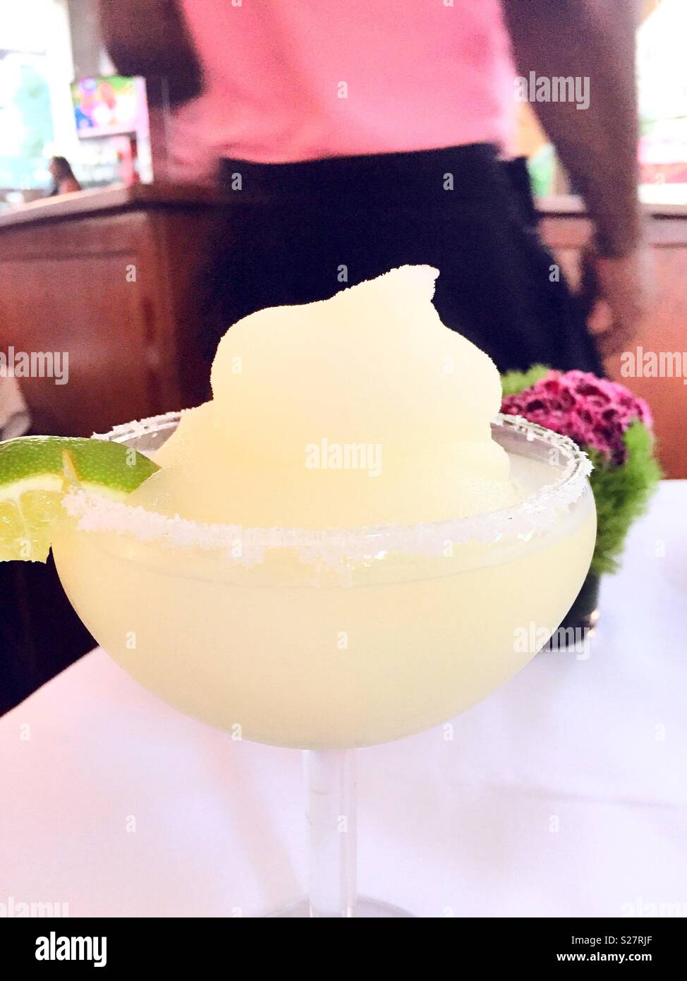 A frozen margarita is served by a waiter in a restaurant, USA Stock Photo