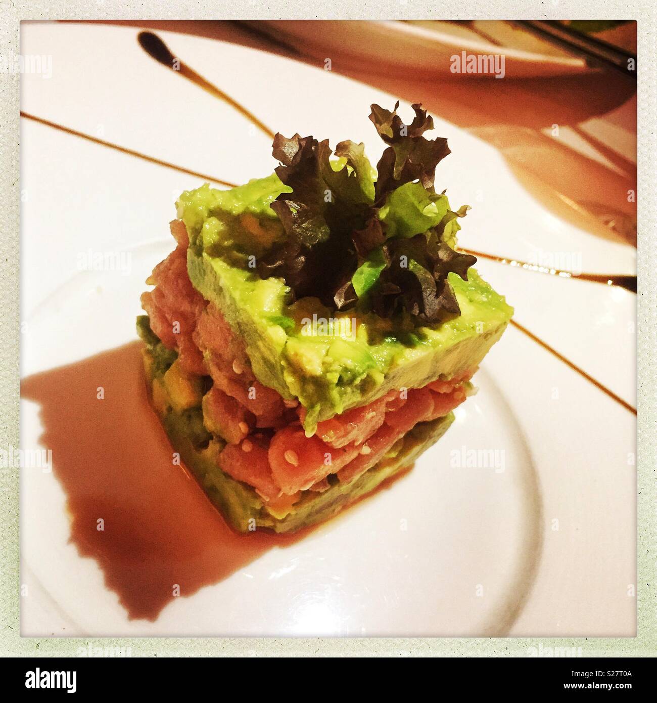 Tuna tartare scented with yuzu juice, lime, white sesame and layers of avocado, an appetizer at Spasso Italian bar and restaurant, Tsim Sha Tsui, Kowloon, Hong Kong - Smartphone Captured Stock Image