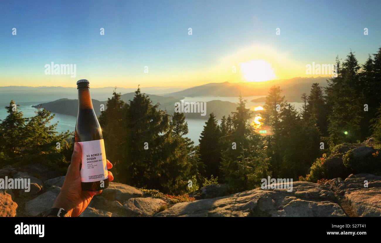 Sunset beers on top of a mountain Stock Photo