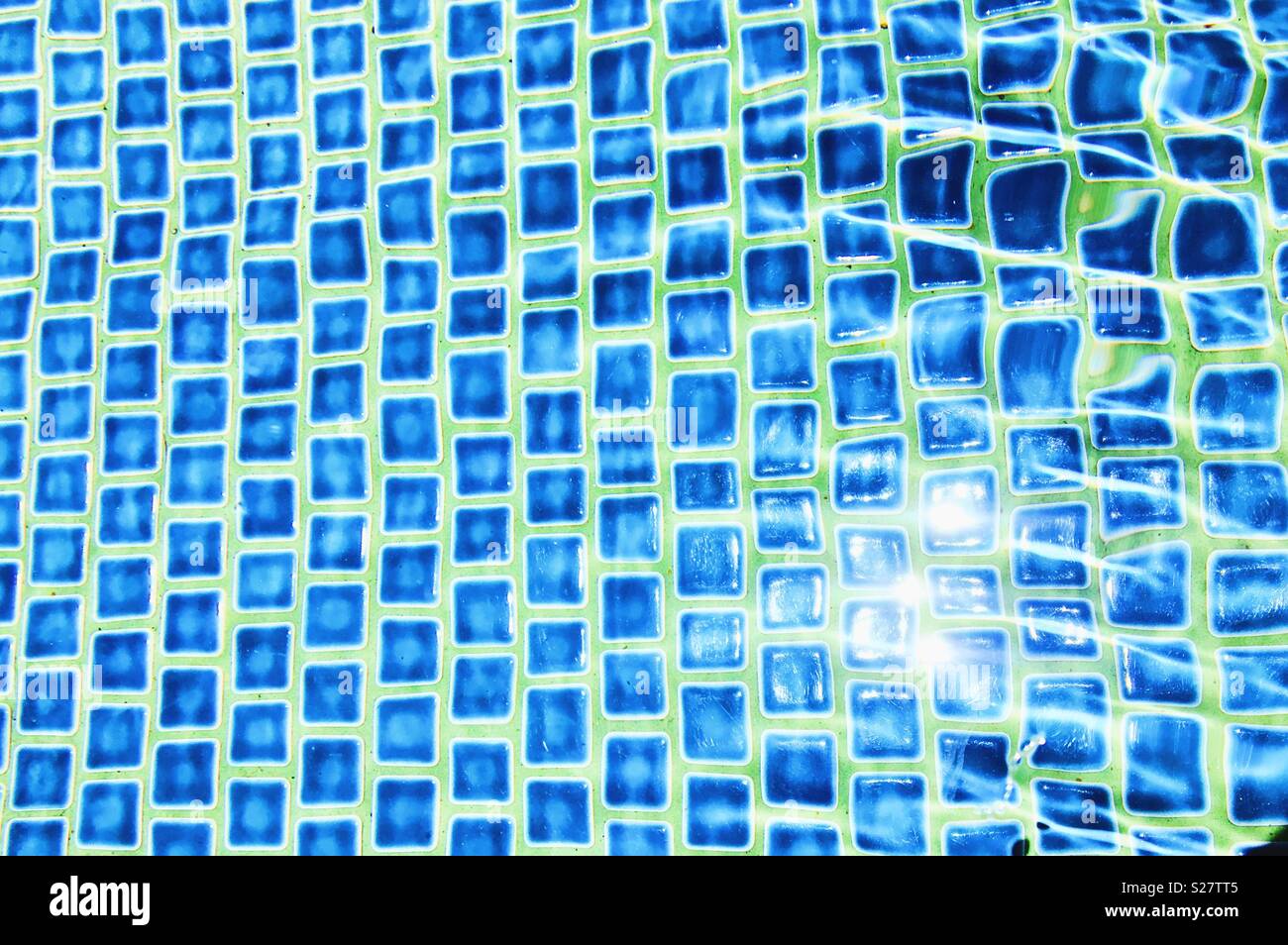 Mosaic tiles under water outdoors on a sunny day. - Smartphone Captured Stock Image