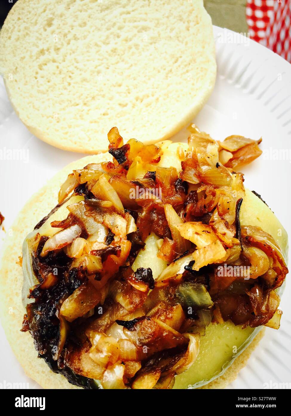 Cheeseburger with onions in a white bread burger bun. - Smartphone Captured Stock Image