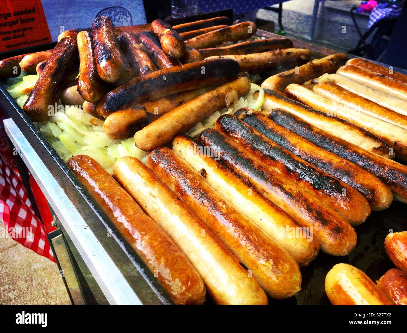 Grilled hotdog sausages and fried onions. - Smartphone Captured Stock Image