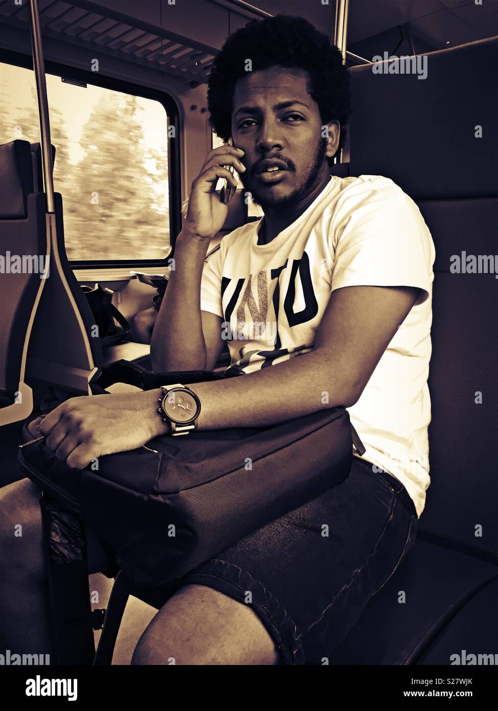 Passenger using his mobile phone - Smartphone Captured Stock Image