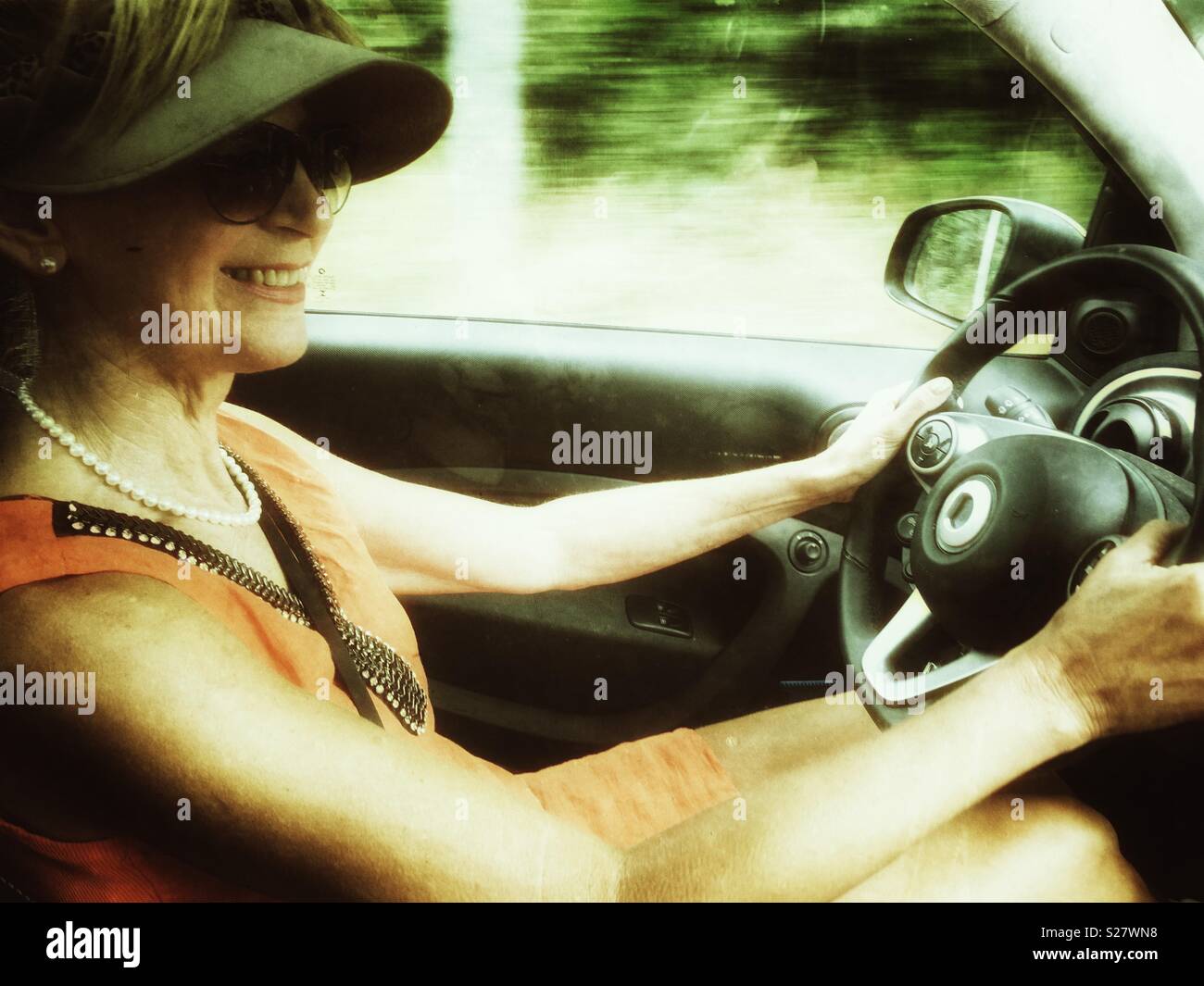 Woman driving a Smart car - Smartphone Captured Stock Image