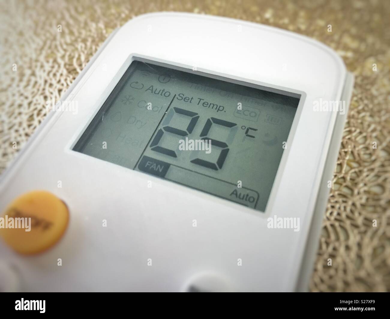 Display of an air conditioner remote control with temperature set at 25 degrees - Smartphone Captured Stock Image